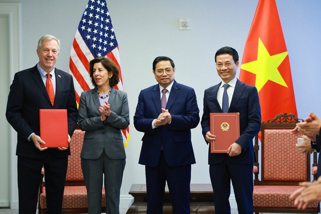 Bộ trưởng Bộ Thông tin và Truyền thông Nguyễn Mạnh Hùng và nguyên Đại sứ Hoa Kỳ tại Việt Nam Ted Osius trao thỏa thuận hợp tác trong lĩnh vực công nghệ thông tin và truyền thông. Ảnh: VGP